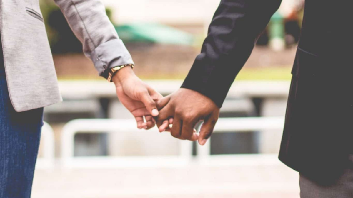 Pregnant man and multi-racial handshake among gender-neutral